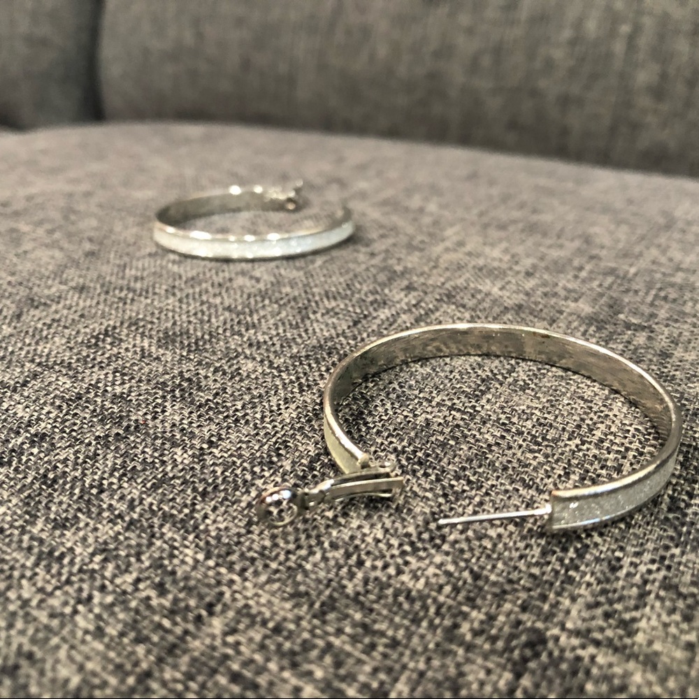 Silver loop earrings with tiny crystals around the width